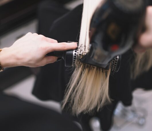 crop-stylist-setting-hair-with-brush